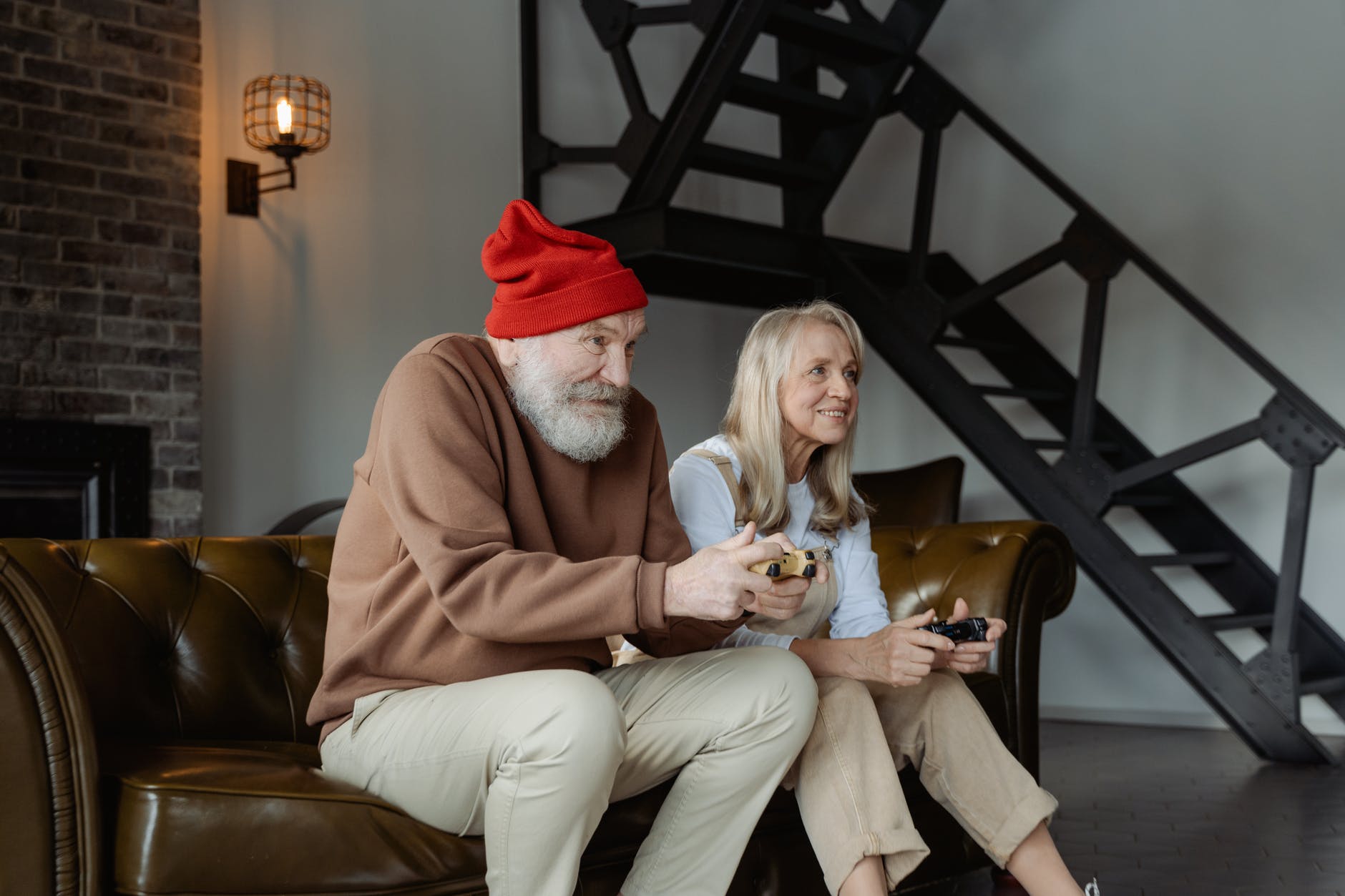 man and woman sitting on brown leather sofa