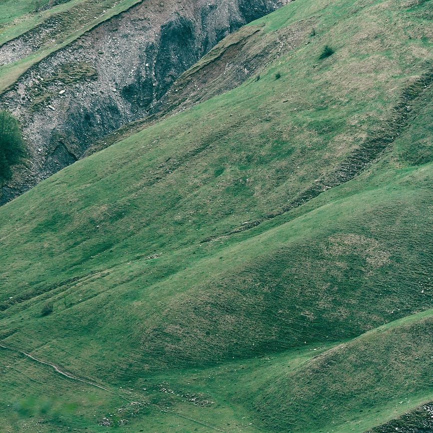 picturesque scenery of green uneven slope of mountain