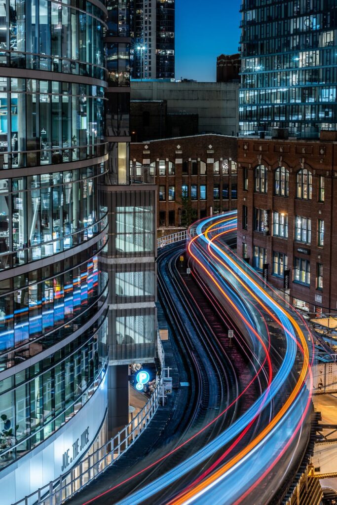 time lapse photography of railway and building during nighttime